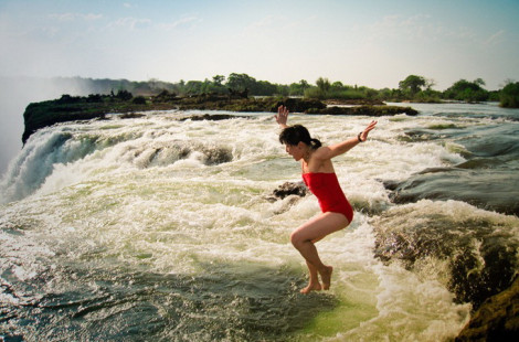 Девушки купаются у самого края водопада Виктория в Замбии