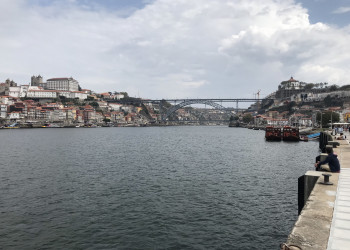 Набережная реки Дуэро с видом на мост Понти-ди-Дон-Луиш I, город Порту – фотографии Португалии