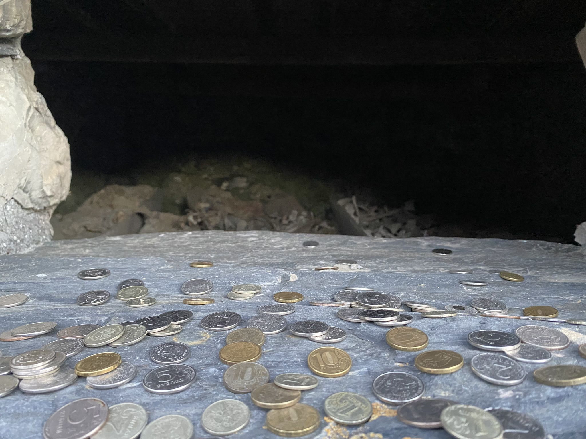 Монетки в окошках склепа Даргавса - города мертвых в Северной Осетии – фотографии России